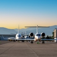 general aviation parked on ramp by hangars 