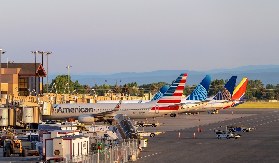 airlines parked at gate, terminal construction going on in background